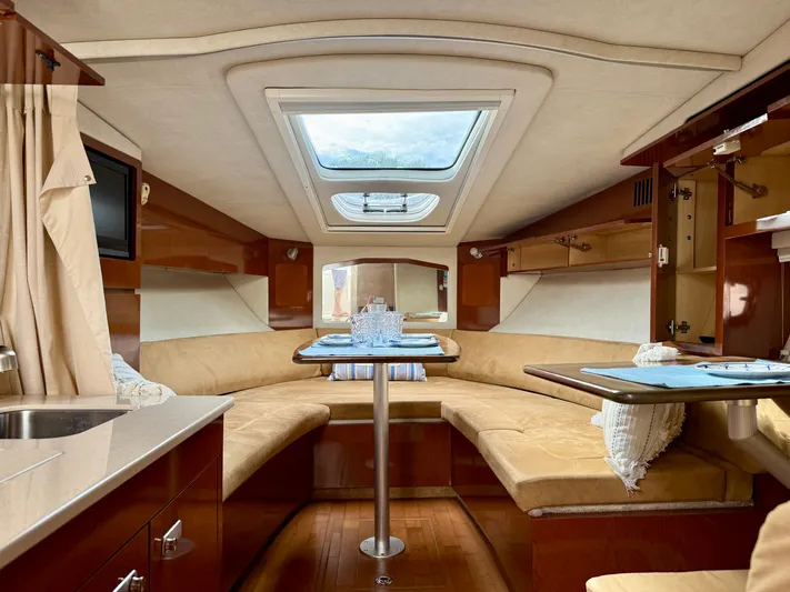 Just Us Yacht Photos Pics Luxurious interior of 2010 Sea Ray 310 Sundancer yacht with elegant seating and skylight.