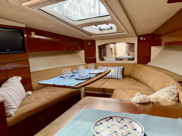 Just Us Yacht Photos Pics Interior of 2010 Sea Ray 310 Sundancer with cozy seating and dining area.