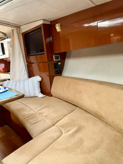 Just Us Yacht Photos Pics Interior of 2010 Sea Ray 310 Sundancer with beige seating and wooden cabinetry.