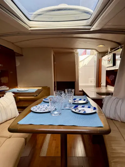 Just Us Yacht Photos Pics Interior of 2010 Sea Ray 310 Sundancer with elegant dining setup and skylight.