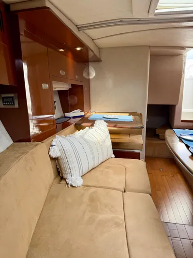 Just Us Yacht Photos Pics Luxurious interior of 2010 Sea Ray 310 Sundancer with beige seating and wooden accents.