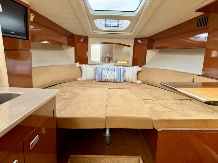 Just Us Yacht Photos Pics Luxurious interior of 2010 Sea Ray 310 Sundancer with plush seating and skylight.