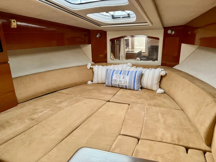Just Us Yacht Photos Pics Luxurious interior of 2010 Sea Ray 310 Sundancer with cozy seating and decorative pillows.