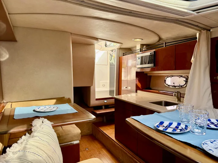 Just Us Yacht Photos Pics Interior of 2010 Sea Ray 310 Sundancer yacht with kitchen and dining area.