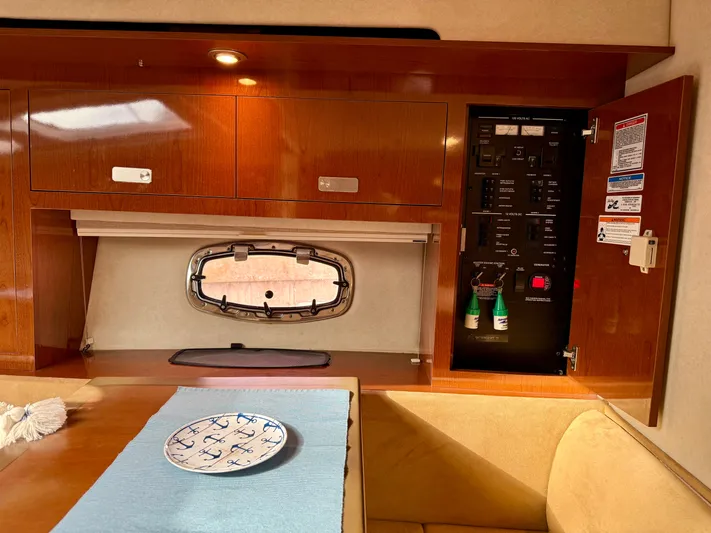 Just Us Yacht Photos Pics 2010 Sea Ray 310 Sundancer cabin interior with control panel and porthole.