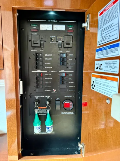 Just Us Yacht Photos Pics Electrical panel of a 2010 Sea Ray 310 Sundancer boat with labeled switches and warnings.