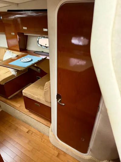 Just Us Yacht Photos Pics Interior of 2010 Sea Ray 310 Sundancer with wood finishes and cozy seating area.