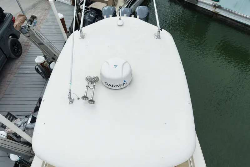  Yacht Photos Pics 2015 Cobia 344 Center Console boat with Garmin equipment, docked by the water.