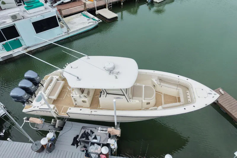  Yacht Photos Pics 2015 Cobia 344 Center Console boat docked in marina, aerial view.