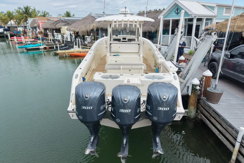  Yacht Photos Pics 2015 Cobia 344 Center Console boat with triple Yamaha 300 engines docked at marina.