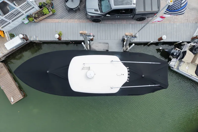  Yacht Photos Pics Overhead view of a 2015 Cobia 344 Center Console boat docked with cover.