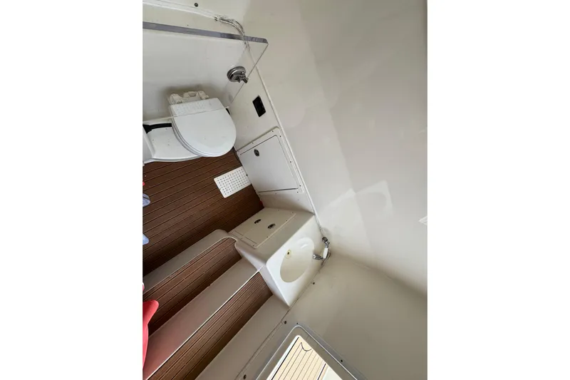  Yacht Photos Pics 2015 Cobia 344 Center Console boat interior with toilet and sink.