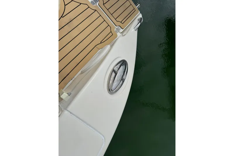  Yacht Photos Pics 2015 Cobia 344 Center Console boat deck with wood finish and water reflection.