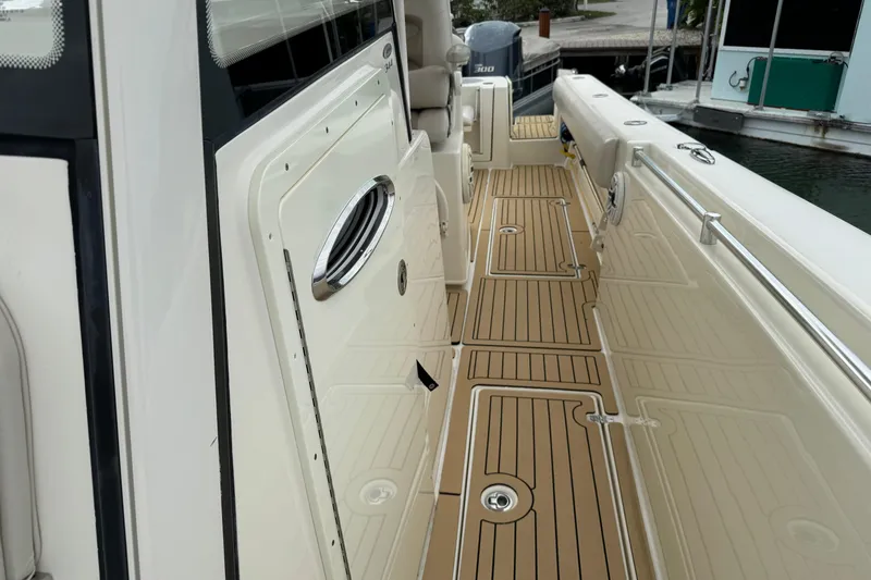  Yacht Photos Pics 2015 Cobia 344 Center Console boat with teak-style deck, docked at marina.