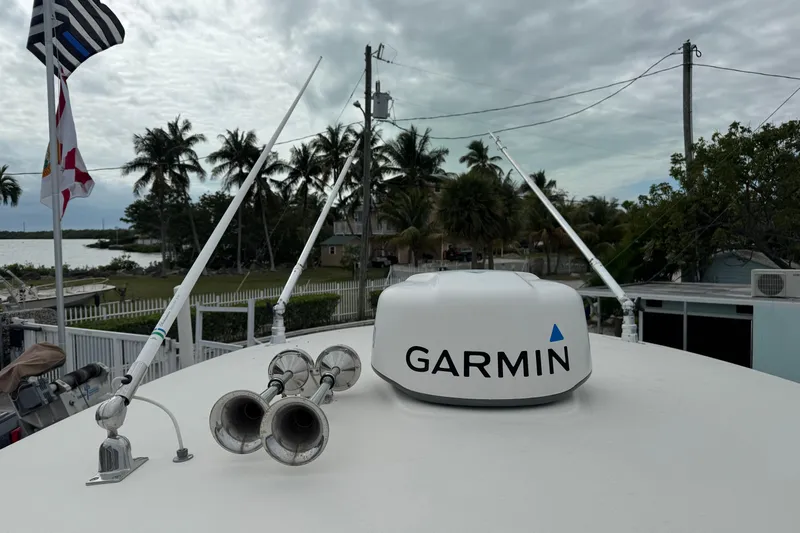  Yacht Photos Pics 2015 Cobia 344 Center Console with Garmin radar and antennas, tropical background.