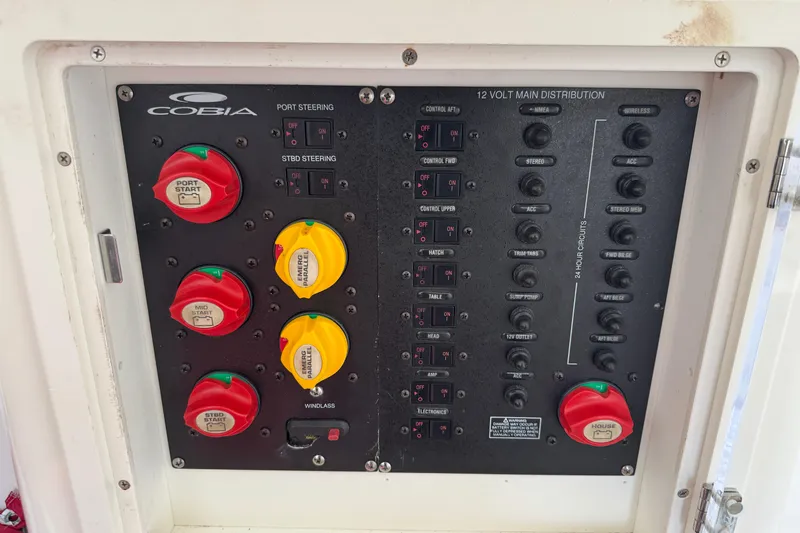  Yacht Photos Pics Control panel of a 2015 Cobia 344 Center Console boat, featuring switches and circuit breakers.