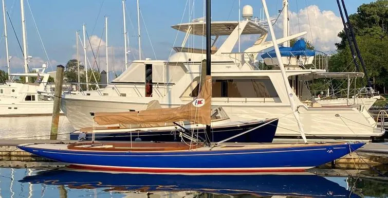 Caprice Yacht Photos Pics 2023 C.W. Hood 32 Daysailer docked, featuring sleek blue hull and tan sail cover.