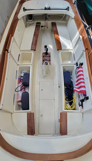Caprice Yacht Photos Pics 2023 C.W. Hood 32 Daysailer interior with storage compartments and American flag.