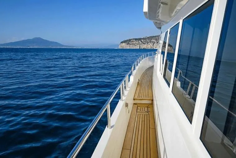  Yacht Photos Pics Moonen 68 yacht cruising on open sea, 1995 model, with scenic coastal view.