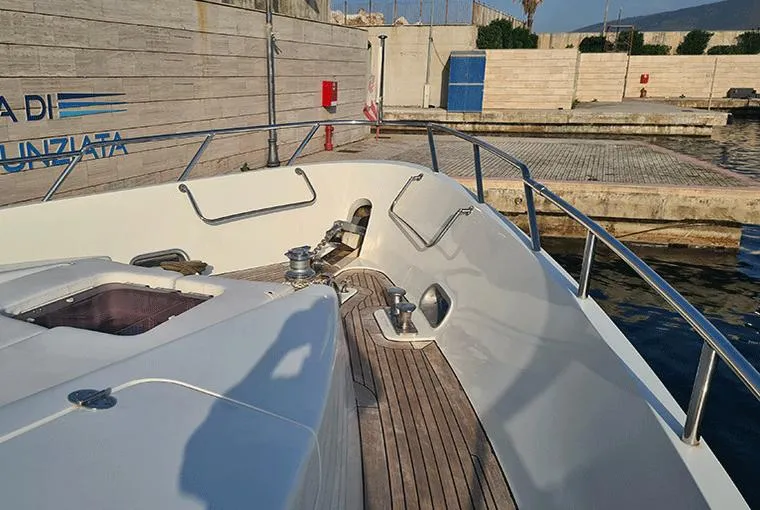  Yacht Photos Pics Bow of a 1995 Moonen 68 yacht with wooden deck and metal railings.
