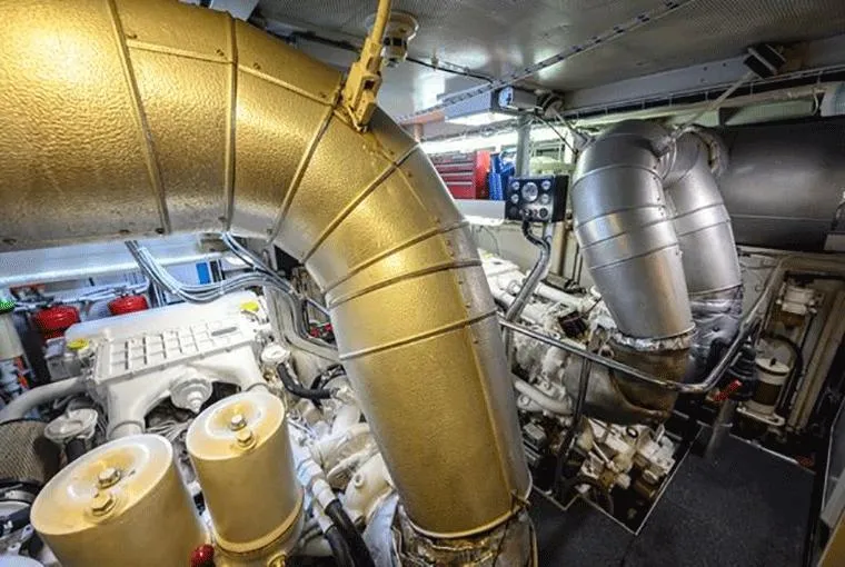  Yacht Photos Pics Engine room of a 1995 Moonen 68 yacht, featuring large metallic pipes and machinery.
