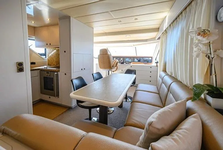  Yacht Photos Pics Luxurious interior of a 1995 Moonen 68 yacht with modern seating and dining area.