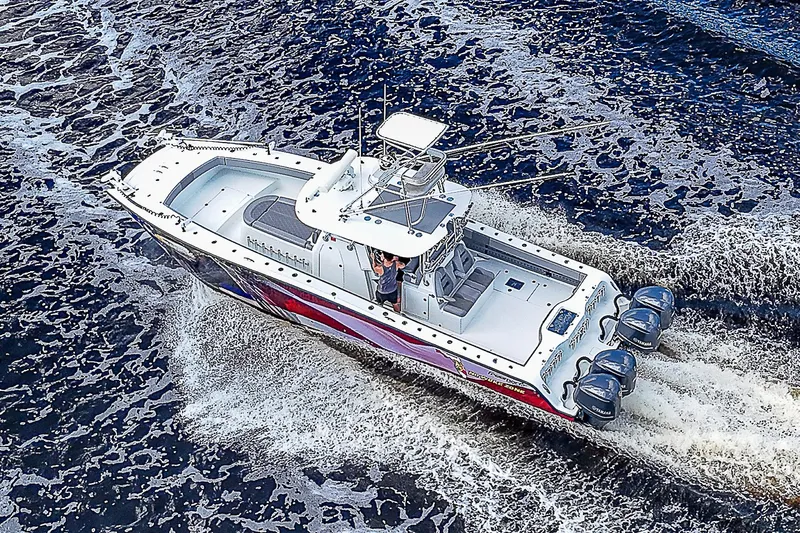 No Woke Zone Yacht Photos Pics Aerial view of 2019 Freeman 37 boat cruising on water with three outboard motors.