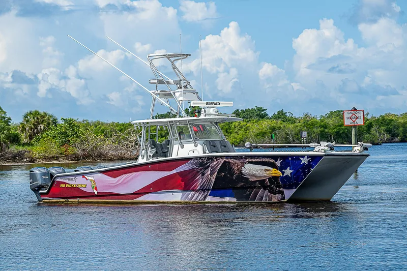 No Woke Zone Yacht Photos Pics Freeman 37 boat with American flag and eagle design, 2019 model, on a calm waterway.