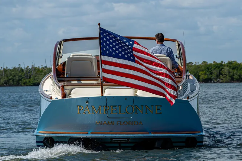 Pampelonne Yacht Photos Pics 2018 Hinckley 34 Runabout boat with American flag, cruising on water.
