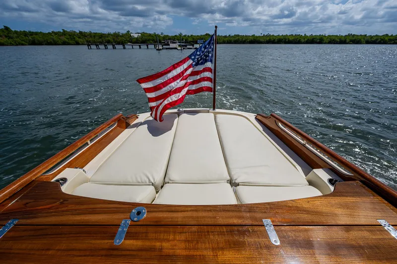 Pampelonne Yacht Photos Pics 2018 Hinckley 34 Runabout with American flag on calm waters.