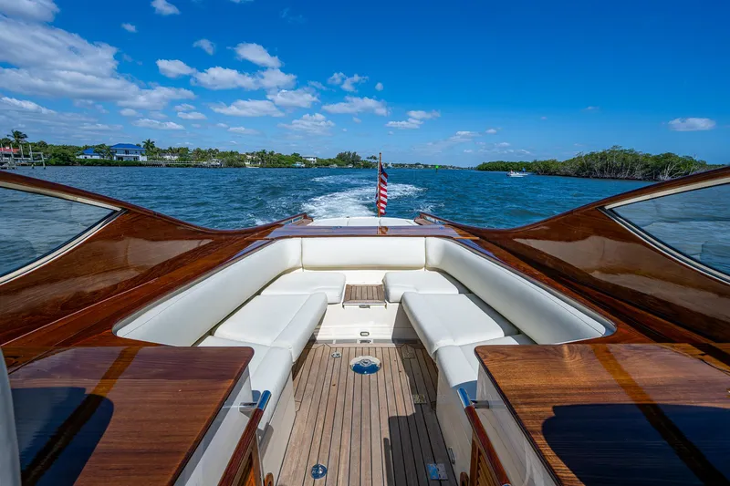 Pampelonne Yacht Photos Pics 2018 Hinckley 34 Runabout cruising on a sunny day, featuring elegant wooden deck and seating.