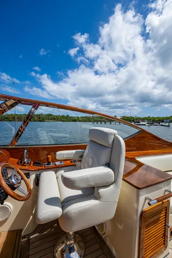 Pampelonne Yacht Photos Pics 2018 Hinckley 34 Runabout yacht interior with luxurious seating and wooden accents under a clear blue sky.