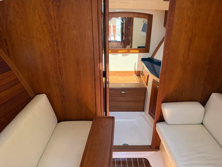 Pampelonne Yacht Photos Pics Interior of 2018 Hinckley 34 Runabout with wooden finish and white seating.