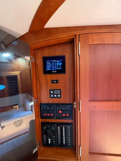 Pampelonne Yacht Photos Pics 2018 Hinckley 34 Runabout interior with control panel and wooden cabinetry.