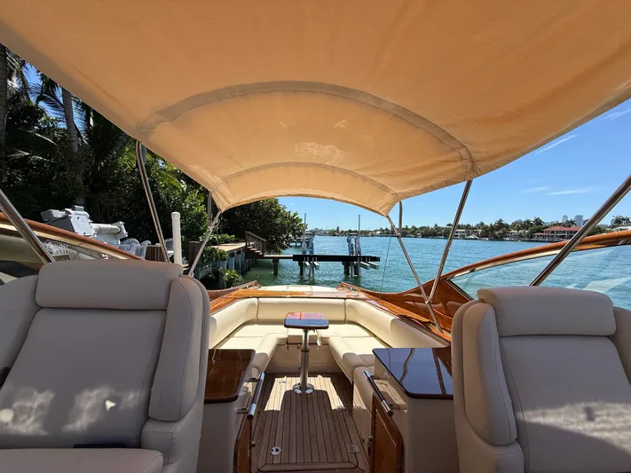 Pampelonne Yacht Photos Pics 2018 Hinckley 34 Runabout boat interior with canopy, featuring luxurious seating and scenic water view.