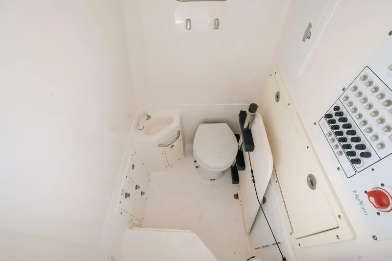  Yacht Photos Pics 2017 Edgewater 318CC boat interior with toilet and control panel.
