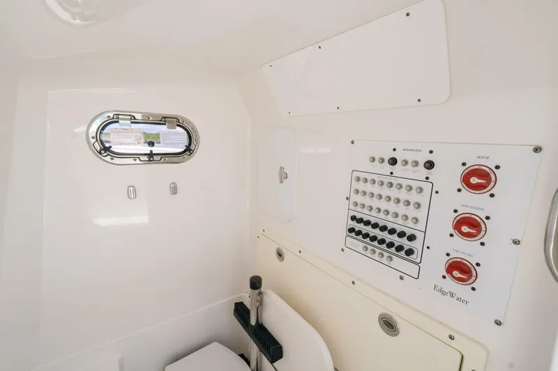  Yacht Photos Pics Interior of 2017 Edgewater 318CC boat showing control panel and porthole.
