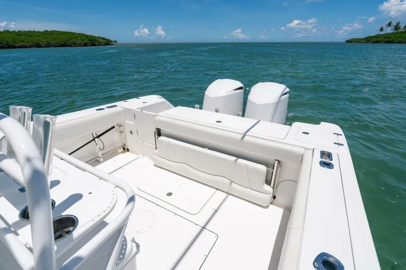  Yacht Photos Pics 2017 Edgewater 318CC boat on open water, featuring dual engines and spacious deck.