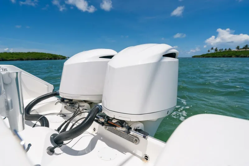  Yacht Photos Pics 2017 Edgewater 318CC boat engines on open water under clear blue sky.