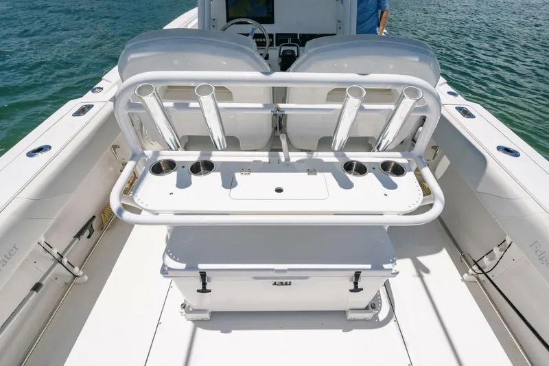  Yacht Photos Pics 2017 Edgewater 318CC boat interior with rod holders and seating, on calm water.