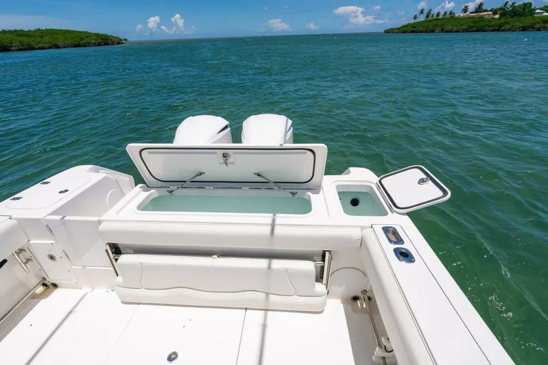  Yacht Photos Pics 2017 Edgewater 318CC boat with open storage compartments on a sunny day at sea.