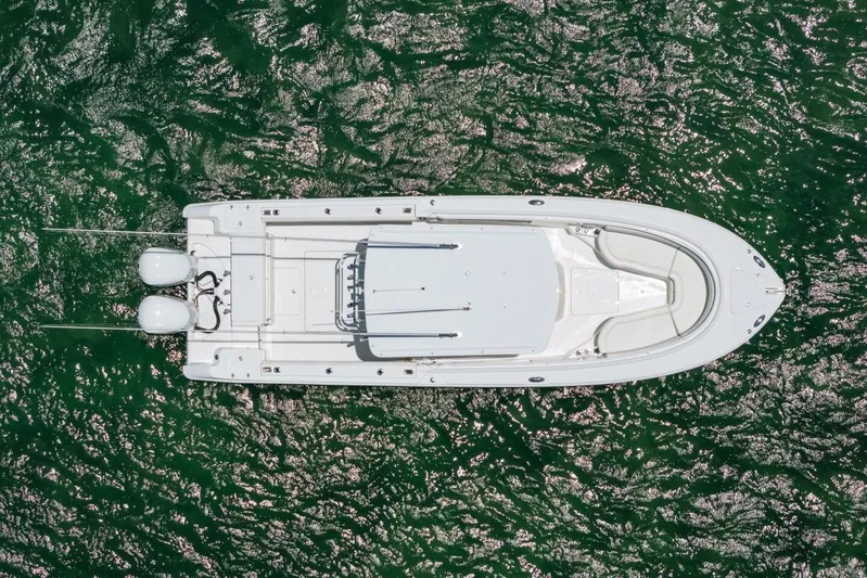  Yacht Photos Pics Aerial view of 2017 Edgewater 318CC boat on shimmering green water.