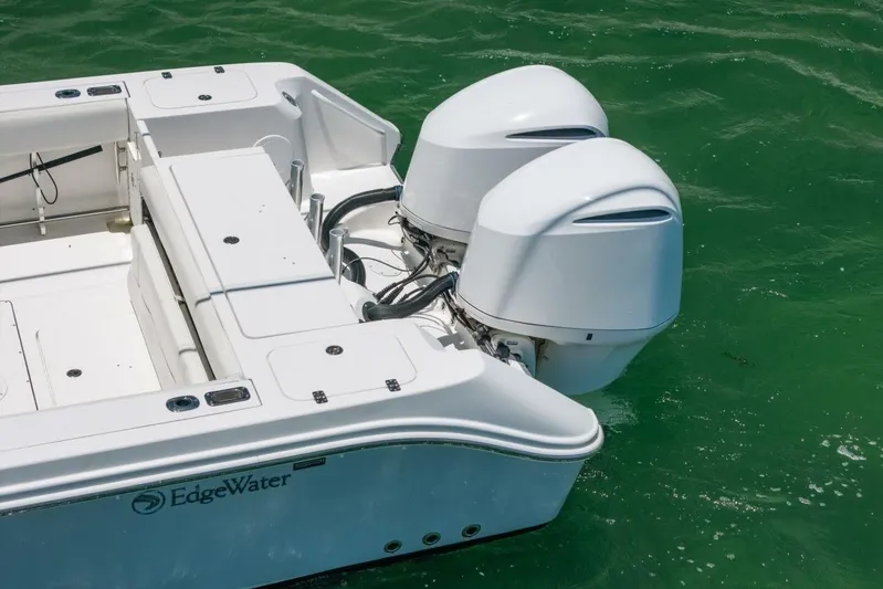  Yacht Photos Pics 2017 Edgewater 318CC boat with dual outboard engines on green water.