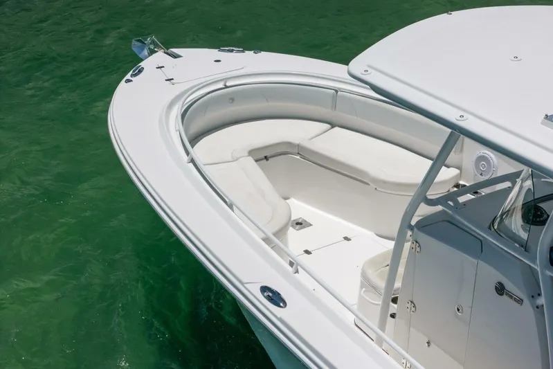  Yacht Photos Pics 2017 Edgewater 318CC boat with white seating, floating on clear green water.