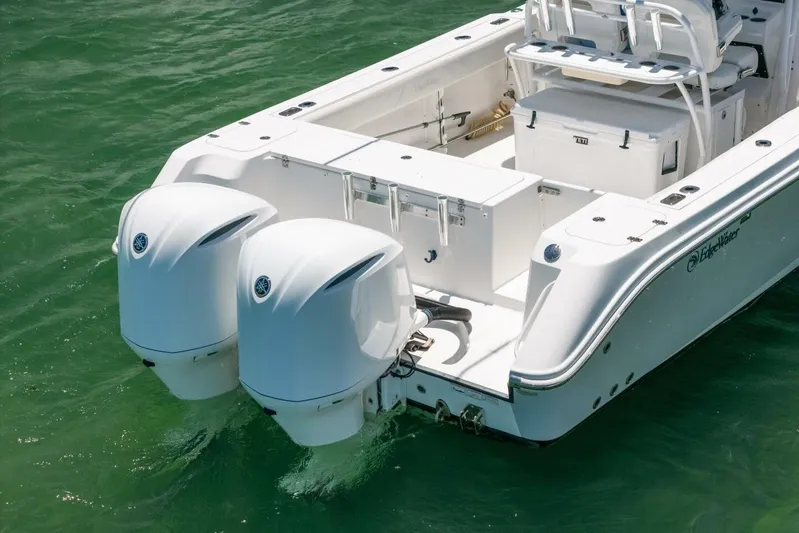  Yacht Photos Pics 2017 Edgewater 318CC boat with dual outboard engines on clear water.