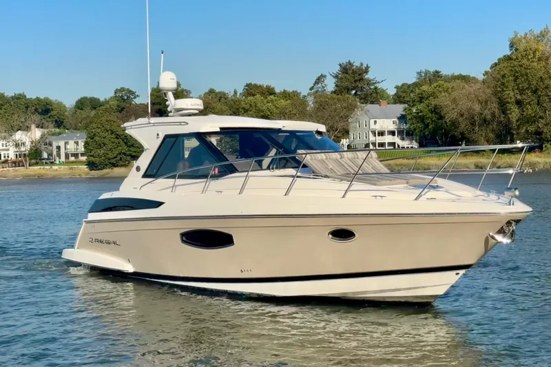  Yacht Photos Pics 2018 Regal 42 Sport Coupe yacht cruising on a calm river with scenic background.