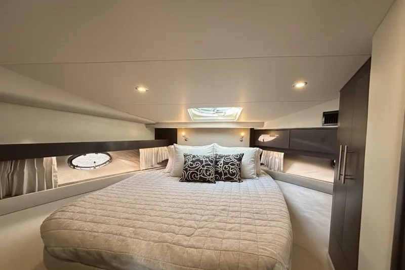  Yacht Photos Pics Luxurious bedroom interior of 2018 Regal 42 Sport Coupe yacht with elegant bedding.