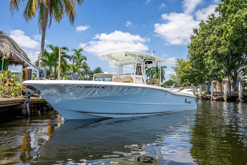  Yacht Photos Pics 2020 Key West Billistic 281 boat on a sunny day, docked near palm trees.