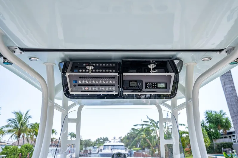  Yacht Photos Pics 2020 Key West Billistic 281 boat console with electronic controls, set against a tropical marina backdrop.