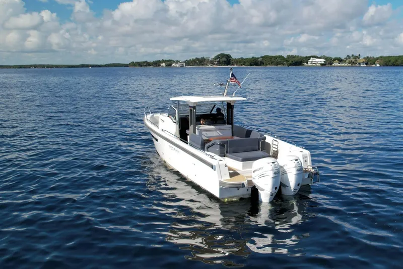 T/t Sophia Yacht Photos Pics 2022 Nimbus T11 boat on calm water under a partly cloudy sky.